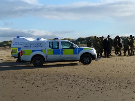 Bomb disposal team on beach