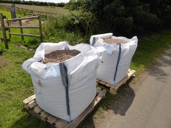 The salmon pink granite chippings arrive on site