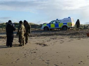 Bomb disposal team on beach