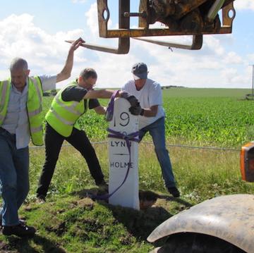 The milestone is lowered into its rightful place
